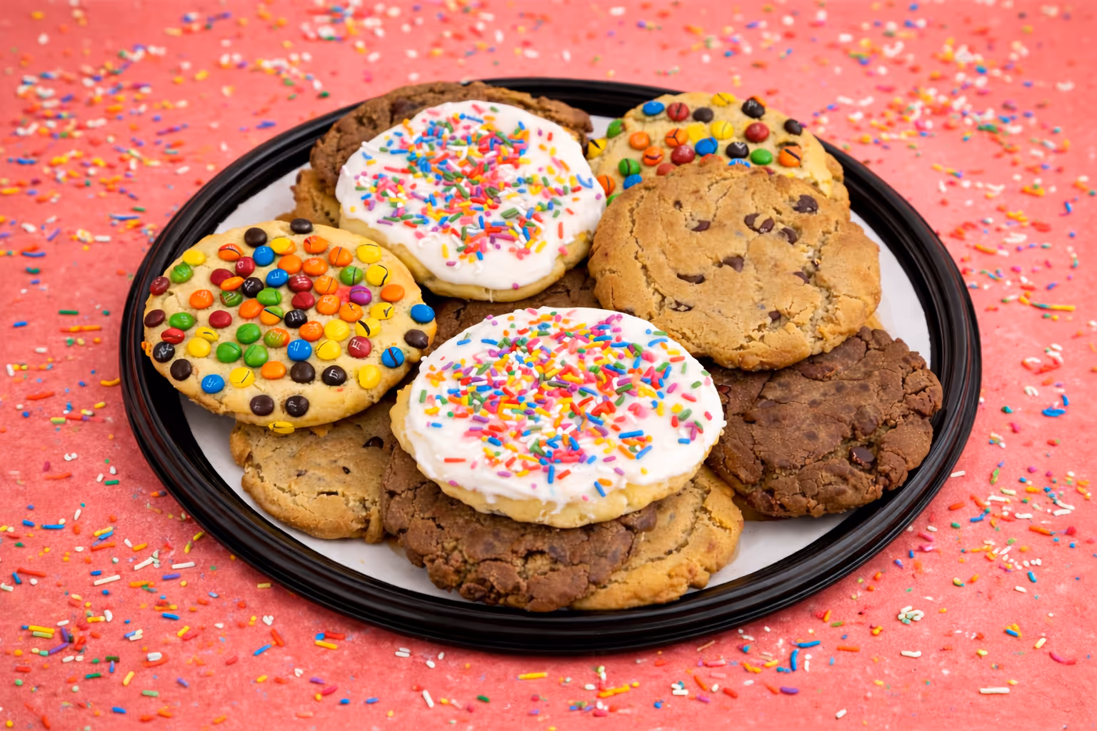 Oversized bakery-style cookies with colorful sprinkles on a plate