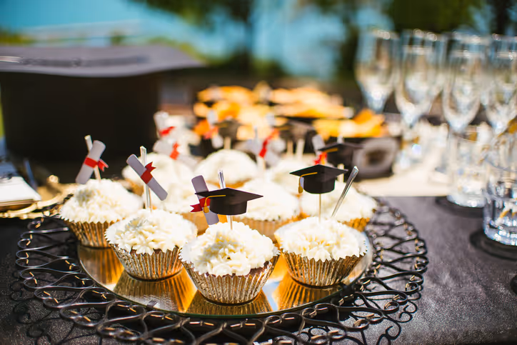Graduation party catering spread with cookie trays from Cookie Dough Creations in Naperville